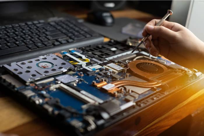 computer-repair-technician Technician performing computer repair on a laptop - Tech It or Leave It expert services